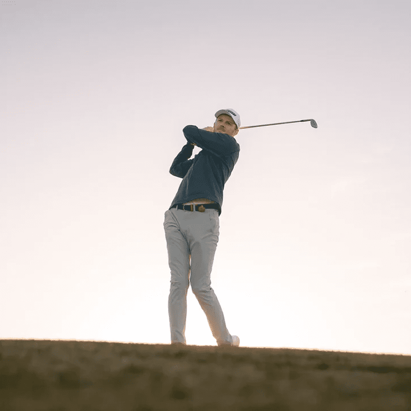 Person playing golf under clear sky