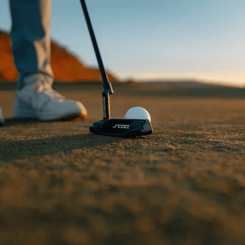 Golfer preparing to putt at sunset