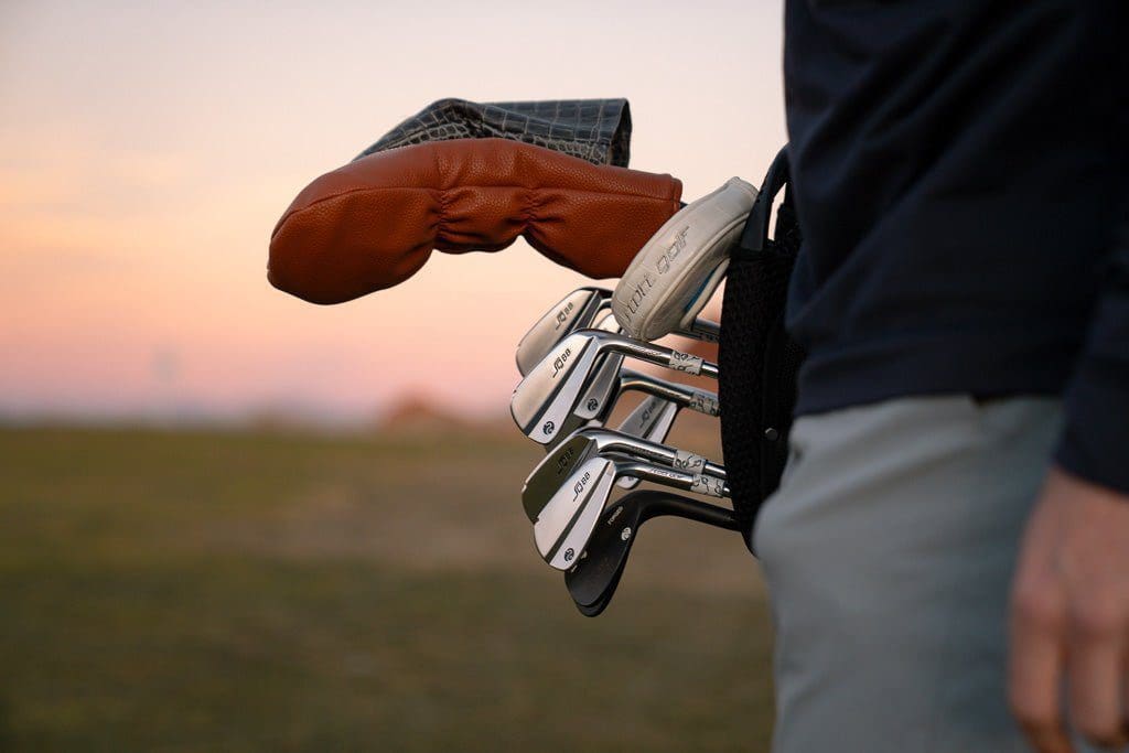 Close-up of golf clubs and leather cover