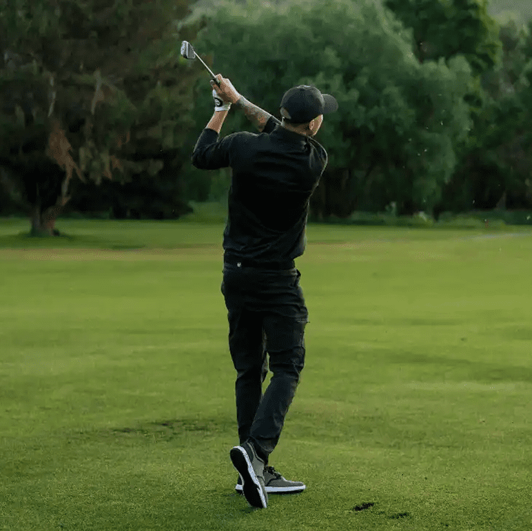 Person playing golf on a sunny day.