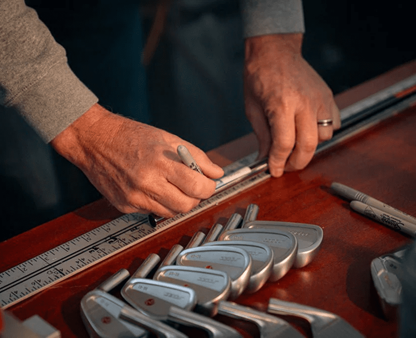 Person marking golf club lengths