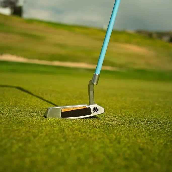 Close-up of putter on putting green