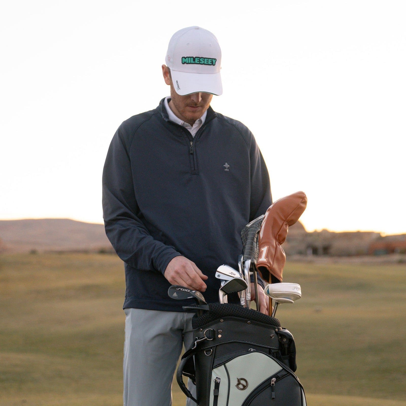 Person in cap preparing for golf game