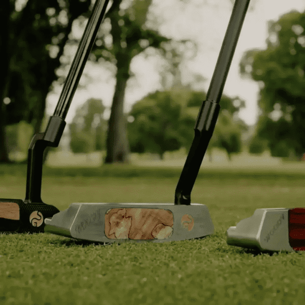 Unique putters on a golf course green