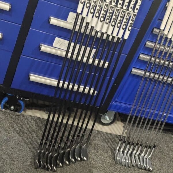 Golf clubs arranged in a row